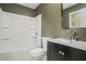 Bathroom features a tub and shower combination, dark vanity, and neutral walls at 5400 Louis Xiv Ln, Atlanta, GA 30349