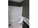 Modern bathroom featuring a shower-tub combo, white shower surround and dark gray walls at 5400 Louis Xiv Ln, Atlanta, GA 30349