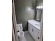Charming half bath featuring modern vanity, black hardware and a modern toilet at 5400 Louis Xiv Ln, Atlanta, GA 30349