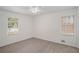 Cozy bedroom with neutral carpet, two windows, and ample natural light at 5400 Louis Xiv Ln, Atlanta, GA 30349
