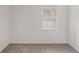 A compact bedroom space with neutral walls and carpet, illuminated by a single window at 5400 Louis Xiv Ln, Atlanta, GA 30349