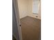 Bright bedroom with neutral carpet, window, and fresh, white paint throughout at 5400 Louis Xiv Ln, Atlanta, GA 30349