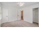 Neutral bedroom with three doors, neutral carpet and one window at 5400 Louis Xiv Ln, Atlanta, GA 30349