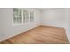 Sunlit bedroom with wood-look flooring and multiple windows at 5400 Louis Xiv Ln, Atlanta, GA 30349