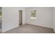 Bright bedroom featuring neutral carpet, closet, and one window at 5400 Louis Xiv Ln, Atlanta, GA 30349