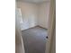 Cozy bedroom featuring neutral carpet, two windows providing natural light, and white trim at 5400 Louis Xiv Ln, Atlanta, GA 30349