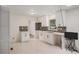 Updated kitchen with white cabinets, gray backsplash, and marble-look tile flooring at 5400 Louis Xiv Ln, Atlanta, GA 30349