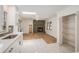 Bright, open kitchen featuring white cabinets, modern appliances, and a view of the living area at 5400 Louis Xiv Ln, Atlanta, GA 30349