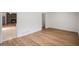 Open-concept living space with wood floors and a brick fireplace at 5400 Louis Xiv Ln, Atlanta, GA 30349