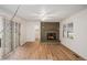 Bright living room featuring a brick fireplace, modern flooring, and a ceiling fan at 5400 Louis Xiv Ln, Atlanta, GA 30349
