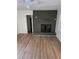 Living room with a brick fireplace, wood floors and natural light at 5400 Louis Xiv Ln, Atlanta, GA 30349
