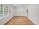 Bright living room featuring wood-look flooring and large windows at 5400 Louis Xiv Ln, Atlanta, GA 30349