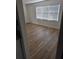 Living room showcasing wood laminate flooring and a large window with natural light at 5400 Louis Xiv Ln, Atlanta, GA 30349