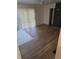 Open-concept living room showcasing wood laminate flooring, brick fireplace, and natural light at 5400 Louis Xiv Ln, Atlanta, GA 30349
