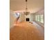Unfinished living room featuring natural lighting, a fireplace, and a staircase at 7216 Eton Ln, Locust Grove, GA 30248
