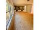 An expansive living room and open floor plan lead to a kitchen area, ready for new flooring at 7216 Eton Ln, Locust Grove, GA 30248