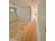 Spacious unfinished room with a chandelier, 3 windows, light colored walls and an entry hallway at 7216 Eton Ln, Locust Grove, GA 30248