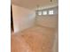 Spacious unfinished room with high ceilings featuring a chandelier, three windows and light-colored walls at 7216 Eton Ln, Locust Grove, GA 30248