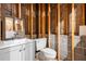 Unfinished basement bathroom with sink, toilet and exposed brick wall at 1491 Stonington Ct, Villa Rica, GA 30180