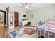 bedroom featuring a white dresser, colorful rug, ceiling fan, and light-green walls at 1491 Stonington Ct, Villa Rica, GA 30180