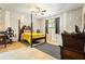 Spacious bedroom features a four-poster bed and large windows with unfinished walls at 1491 Stonington Ct, Villa Rica, GA 30180