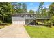 Two-story home with a two-car garage, deck, and siding at 1491 Stonington Ct, Villa Rica, GA 30180