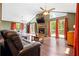 Open living room with high ceilings, stone fireplace, hardwood floors, and natural light at 1491 Stonington Ct, Villa Rica, GA 30180