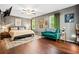 Bedroom with hardwood floors, gray walls, ceiling fan, and many artworks at 1491 Stonington Ct, Villa Rica, GA 30180