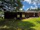 Grassy backyard with a patio, providing an outdoor area for entertaining and leisure activities at 2933 Arlington Rd, East Point, GA 30344