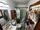 Cozy bathroom featuring a sink, toilet, shower with curtain, and shoe storage at 2933 Arlington Rd, East Point, GA 30344