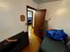 Simple bedroom space showing hardwood floors and natural light, offering potential for customization to suit individual needs at 2933 Arlington Rd, East Point, GA 30344