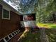 View of the home's exterior showing the backyard addition, with a ladder leaning against the side at 2933 Arlington Rd, East Point, GA 30344