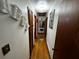 Well-lit hallway with hardwood floors and neutral walls, leading to various rooms, providing a seamless transition between spaces at 2933 Arlington Rd, East Point, GA 30344