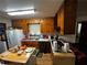 A functional kitchen with wooden cabinets, white appliances, and a cozy, lived-in atmosphere, offering ample counter space at 2933 Arlington Rd, East Point, GA 30344