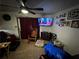 Living room showcasing a ceiling fan, curtains, TV, and an array of pictures on the wall at 2933 Arlington Rd, East Point, GA 30344