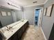 Well-lit bathroom with a double vanity, large mirror, and neutral color scheme at 3201 Palisades Se Ct, Marietta, GA 30067