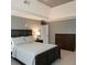 Comfortable bedroom with a tray ceiling, gray walls, and coordinated furniture at 3201 Palisades Se Ct, Marietta, GA 30067