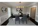 Elegant dining room with stylish light fixture, modern artwork, and large window for ample natural light at 3201 Palisades Se Ct, Marietta, GA 30067