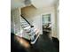 Elegant foyer features a staircase with dark wood floors, chandelier, and view into a sunlit sitting room at 3201 Palisades Se Ct, Marietta, GA 30067