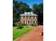 Charming two-story brick home with black shutters, dormer windows, manicured lawn, and brick driveway at 3201 Palisades Se Ct, Marietta, GA 30067
