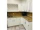 Well-equipped kitchen with granite countertops, white cabinets, wine rack and stainless steel appliances at 3201 Palisades Se Ct, Marietta, GA 30067