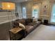 Relaxing living room with comfortable leather sofa, natural light, and hardwood flooring at 3201 Palisades Se Ct, Marietta, GA 30067