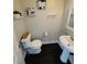 Bright powder room features a pedestal sink, wood-look floors, and contemporary wall decor at 3201 Palisades Se Ct, Marietta, GA 30067