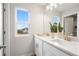 Bright bathroom with double vanity, large mirror, and window views, offering a fresh and modern space at 508 Crown Dr, Emerson, GA 30137