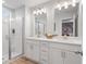 Bright bathroom featuring double vanity with framed mirrors, modern lighting and a glass shower at 508 Crown Dr, Emerson, GA 30137