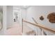 Bright hallway with carpeted floor, white walls and staircase, offering a clean and modern transition between spaces at 508 Crown Dr, Emerson, GA 30137