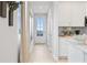 Bright hallway featuring luxury vinyl plank, leading to a door with a view and a modern kitchen at 508 Crown Dr, Emerson, GA 30137