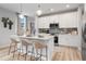 Bright kitchen with white cabinets, island with bar stool seating, and stainless steel appliances at 508 Crown Dr, Emerson, GA 30137