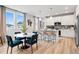 Kitchen and dining area with white cabinets, stainless steel appliances, island, and wood floors at 508 Crown Dr, Emerson, GA 30137