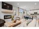 Living room featuring a fireplace, large-screen television, abundant natural light, and wood floors at 508 Crown Dr, Emerson, GA 30137